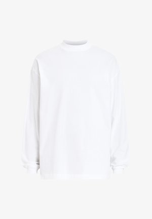 Camiseta de manga larga blanca tipo crewneck hecha de suave tela de algodón. Presenta un corte relajado y puños acanalados para mayor textura. Sin patrones ni gráficos.