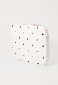 White faux fur laptop sleeve with black embroidered accents, rounded edges, and a pink zipper closure. Soft texture and lightweight design.