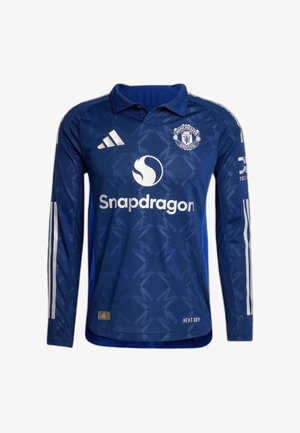 Camiseta de fútbol azul de manga larga hecha de tela texturizada. Presenta rayas blancas en las mangas, un cuello y logotipos impresos en el frente.