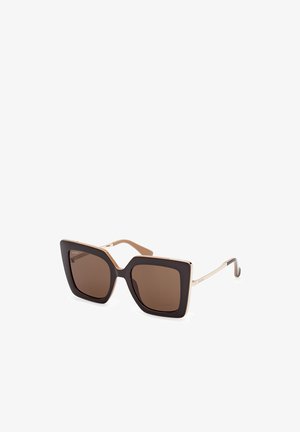 Sunglasses with oversized, square black frames and brown lenses. Gold metal accents on temples enhance the design. Textured finish on frames.