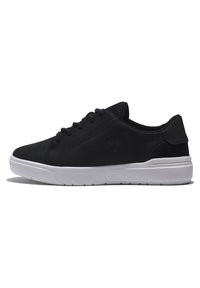 Black sneaker with a smooth upper, featuring a logo, white sole, and lace-up design; texture appears soft and durable.