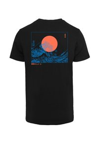 Black t-shirt featuring a blue graphic of waves and a large orange sun, with Japanese text below. Clean, contrasting design.