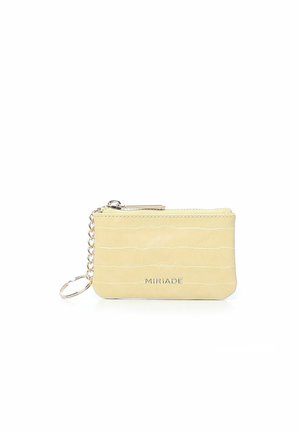 Yellow croc-embossed wallet with silver zipper, keychain attachment, and embossed "MIRIACE" logo on the front. Compact design.