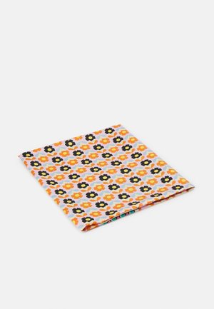 Opgevouwen stof met een herhalend patroon van oranje en zwarte bloemen met blauwe bladeren op een witte achtergrond.