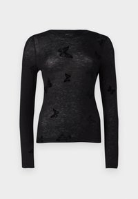 Haut noir à manches longues en maille, présentant un tissu transparent et des motifs de papillons noirs en relief sur toute la surface. Encolure ronde et coupe ajustée.