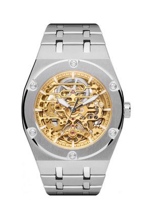 Silver metal wristwatch with visible gold skeleton dial showing intricate gears and mechanical parts, with hour, minute, and second hands.