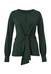 Zelený top s dlouhými rukávy a zavazovacím detailem vpředu, vyrobený z hladké látky. Má zaoblený výstřih a jemný klíčový otvor na přední straně.
