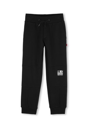 Pantalon de jogging noir avec taille et poignets élastiques, cordon de serrage, poches latérales et patch logo Hugo Worldwide sur la cuisse gauche.