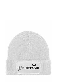 White knit beanie with a folded cuff. Features a black patch with the text "Prinzessin" and a crown design. Textured fabric.