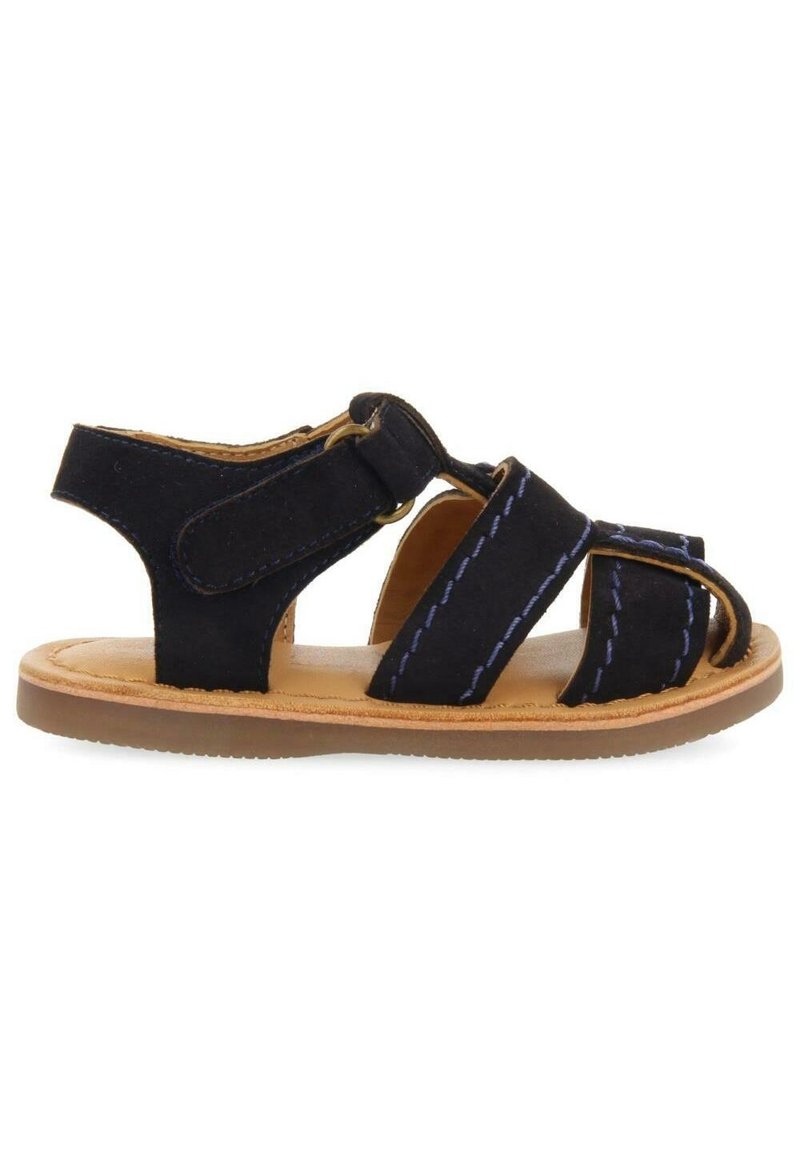Black suede sandal with elastic straps and a tan rubber sole. Features blue stitching on straps and an adjustable hook-and-loop closure.
