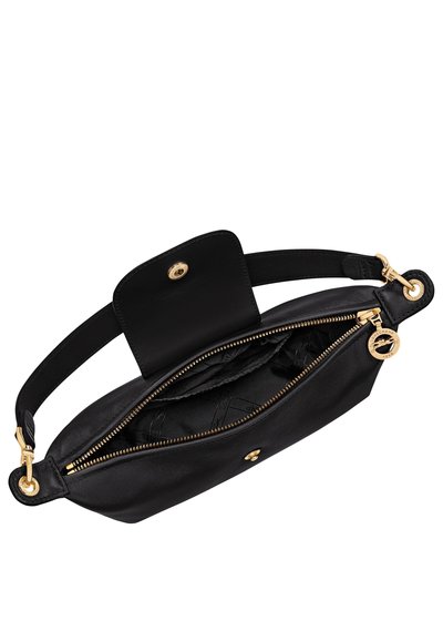 Black leather wristlet bag with gold zipper, snap closure flap, and strap, showing interior lining and logo zipper pull charm.