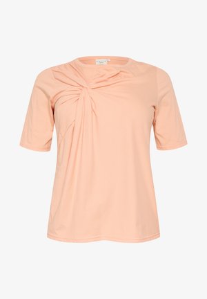 Svetlo broskyňový tričko s krátkym rukávom, ktoré má na prednej strane skrútený dizajn, vyrobené z jemnej, ľahkej látky s okrúhlym výstrihom.