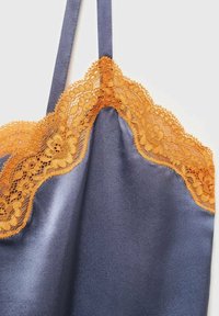 Satin camisole in deep navy with orange lace trim along the neckline, featuring fine floral patterns and adjustable straps.