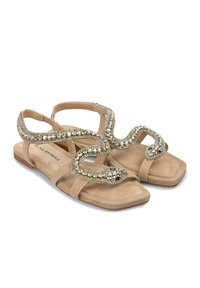 Beige flache Sandalen mit quadrater Zehenform, die ein mit Perlen gestaltetes Schlangenmotiv auf den Riemen haben. Aus weichem Wildleder mit strukturierter Oberfläche.