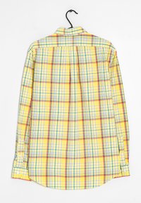 Yellow plaid shirt with blue and red grid patterns, long sleeves, buttoned cuffs, and a folded collar, displayed on a hanger.