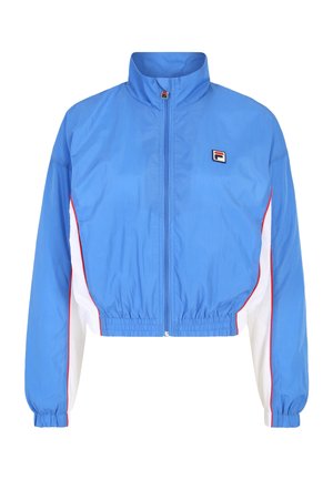 Geknipte blauwe windbreaker met hoge kraag, ritssluiting, witte zijkanten en rode bies. Bevat een klein logo op de borst.