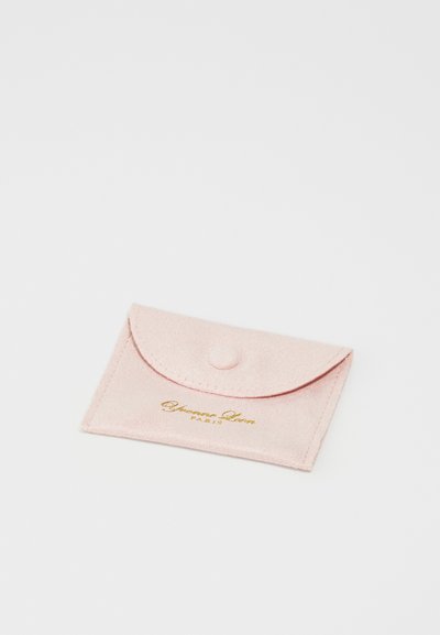 Pink felt wallet with a flap closure and a snap button. Features gold text "Yves Saint Laurent PARIS" on the front. Soft texture.