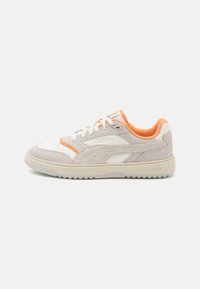 Białe i jasnoszare sneakersy z pomarańczowymi akcentami, wykonane z zamszu i materiałów syntetycznych, z okrągłym noskiem, teksturowanymi bocznymi panelami oraz gumową podeszwą.