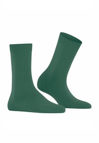 Pair of plain green crew-length socks with ribbed cuffs, displayed against a white background.