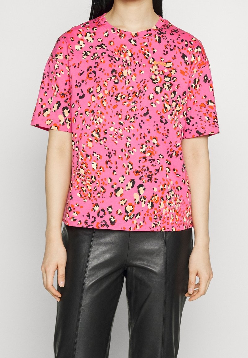 Lyserød kortærmet t-shirt med leopardmønster i nuancer af orange, sort og creme. Letvægts bomuldsstof. Rund halsudskæring.