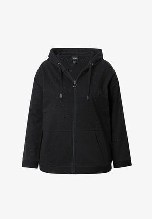 Haut à zip noir avec capuche, en matériau doux. Présente des découpes circulaires sur la surface et des poches avant. Design simple.