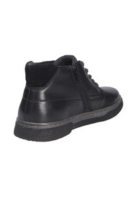 Black leather ankle boot with a textile lining, side zipper, and rubber sole. Features stitched accents and a rounded toe design.