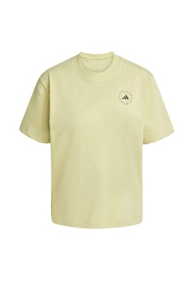 T-shirt en coton jaune clair avec un col rond, des manches courtes et un logo circulaire imprimé sur la zone gauche de la poitrine. Design simple.