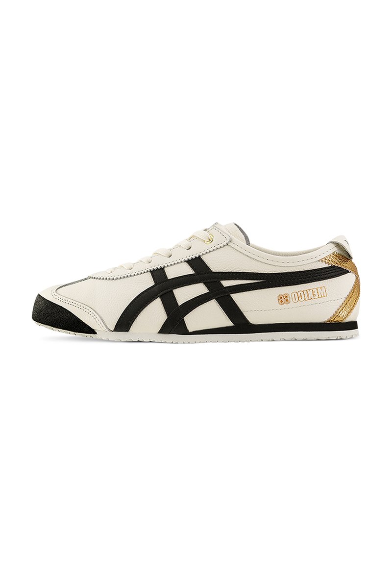 White leather sneakers with black accents, featuring a textured black toe cap and gold branding on the heel, lightweight with a slim profile.
