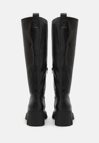 Black knee-high boots with a structured design, made from smooth leather. Thick block heels and side zippers for ease of wear.