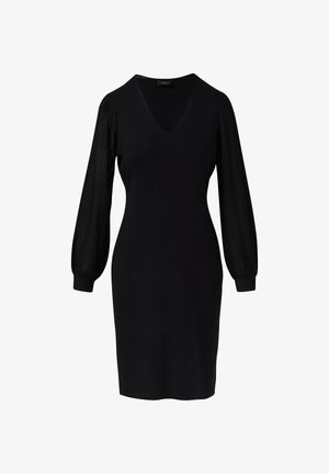 Čierne šaty po kolená s výstrihom do V a priesvitnými dlhými nafúknutými rukávmi, ktoré majú vertikálne pruhy a manžety na zápästí.