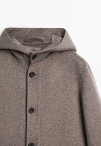 Cappotto di lana marrone con cappuccio, caratterizzato da una texture morbida, cinque bottoni neri e una silhouette classica e dritta.