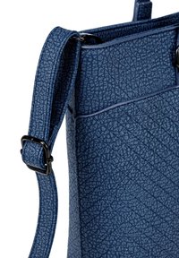 Blue textured handbag made of synthetic material, featuring a diagonal pattern, adjustable strap, and black hardware accents.