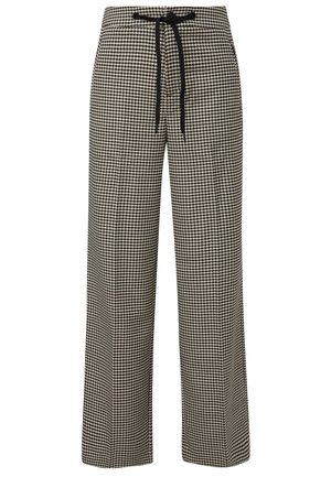 Wide-leg trousers in a black and white houndstooth pattern, featuring a drawstring waist for adjustable fit. Smooth fabric texture.