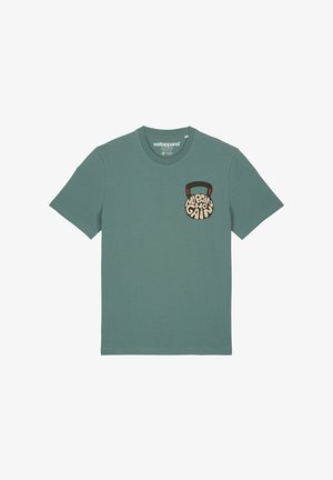 Mint green cotton t-shirt featuring a round, graphic pocket print of a kettlebell with the text "No Pain No Gain" in black and cream.