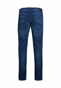 Mörkblå denimjeans med en figurnära design, två bakfickor och en slät yta. Har synliga sömmar och en lapp på midjebandet.