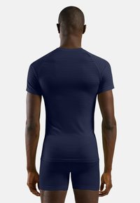 Navy athletic shirt with short sleeves, featuring a textured stripe pattern. The fit is close to the body, made from a lightweight material.