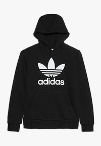 Schwarzer Adidas-Hoodie mit großem weißem Trefoil-Logo und "adidas"-Text auf der Brust, frontaler Kängurutasche und Kapuze.