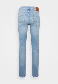 Light blue denim jeans with a straight cut, featuring a brown leather waistband accent and two back pockets with stitched detailing.