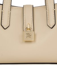 Beżowa skórzana torebka z czarnymi wykończeniami, wyposażona w dwa solidne uchwyty oraz złoty zamek błyskawiczny na przodzie z wytłoczonym logo.