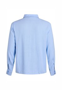 Gaiši zilas krāsas garām piedurknēm krekls, attēlots no aizmugures ar smailu apkakli un pogājamām aprocēm uz baltā fona.