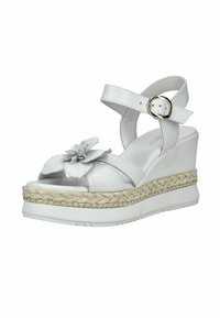 Sandale compensée blanche avec bride à la cheville, boucle dorée, détail en corde tressée sur la semelle, et fleur décorative sur la bride avant.