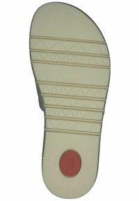 Suola di scarpa di colore chiaro con modelli di presa testurizzati, un accento circolare rosso contrassegnato "Comfort" e un'etichetta di misura "37".