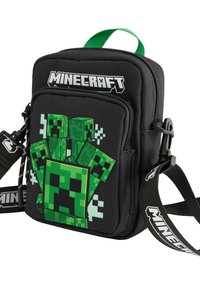 Svart tyg crossbody-väska med en grön pixelart Creeper-design. Inkluderar ett grönt handtag på toppen och en justerbar rem med texten "Minecraft".