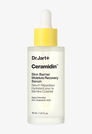 Flacon de sérum avec un bouchon compte-gouttes jaune étiqueté Dr.Jart+ Ceramidin Skin Barrier Moisture Recovery Serum, 30 ml, avec Aqua Cera plus et Acide Hyaluronique au Zinc.