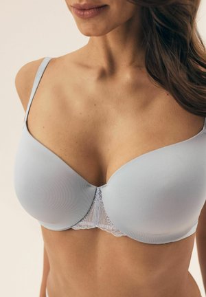 Light blue bra made of smooth material with a lace detail at the center. It features thin adjustable straps and a plunging neckline design.