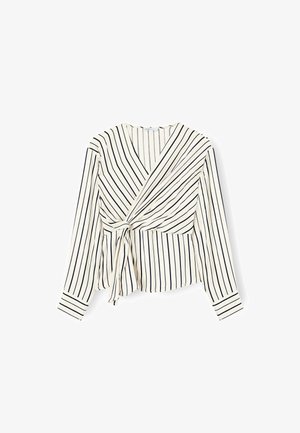 Wrap-style blouse in cream with vertical navy stripes. Long sleeves, tie detail at waist, and v-neck cut. Soft fabric with smooth texture.