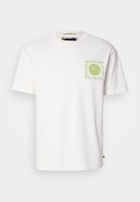 White cotton t-shirt with short sleeves, featuring a green abstract spiral graphic and text on the left chest area. Rounded neckline.