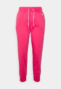 Rosa bomullssweatpants med vit dragsko, avsmalnande ben och ribbade muddar. Har en liten broderad logga på sidan.