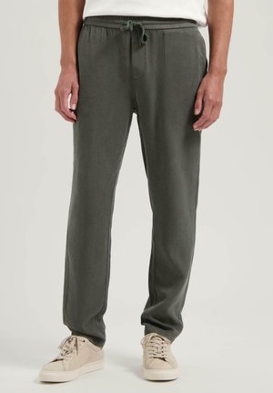 Dark green, lightweight joggers with an elastic waistband and adjustable drawstring. Smooth texture, tapered fit, side pockets, and minimalist design.
