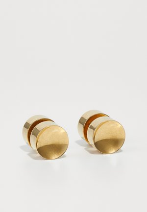Gold metal earrings with a simple round shape, featuring a smooth finish and a central polished band. Measures approximately 1 cm in diameter.